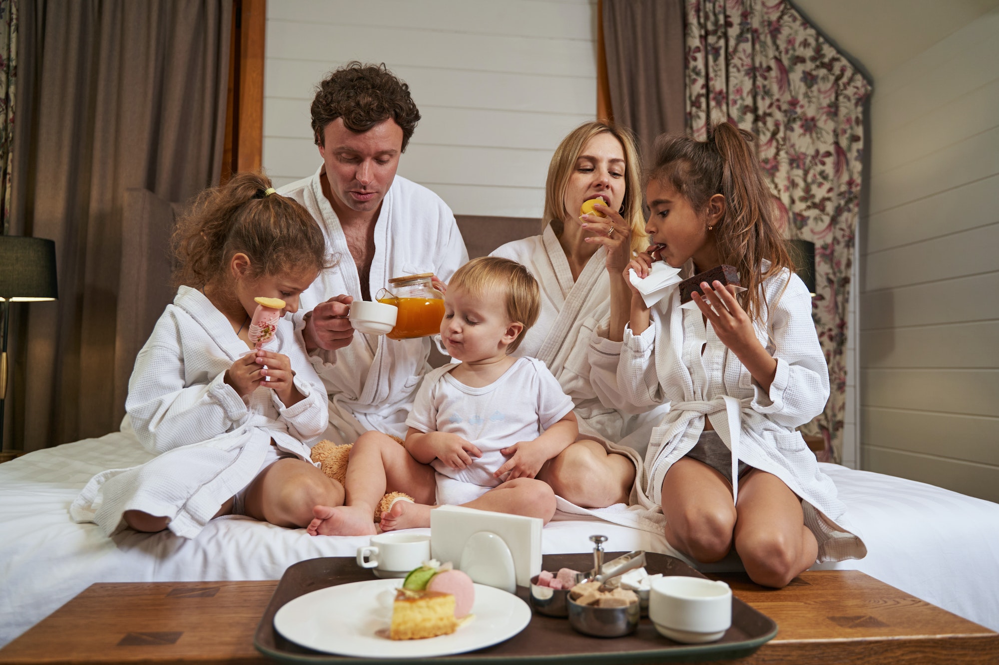 smiling family eating breakfast in the hotel